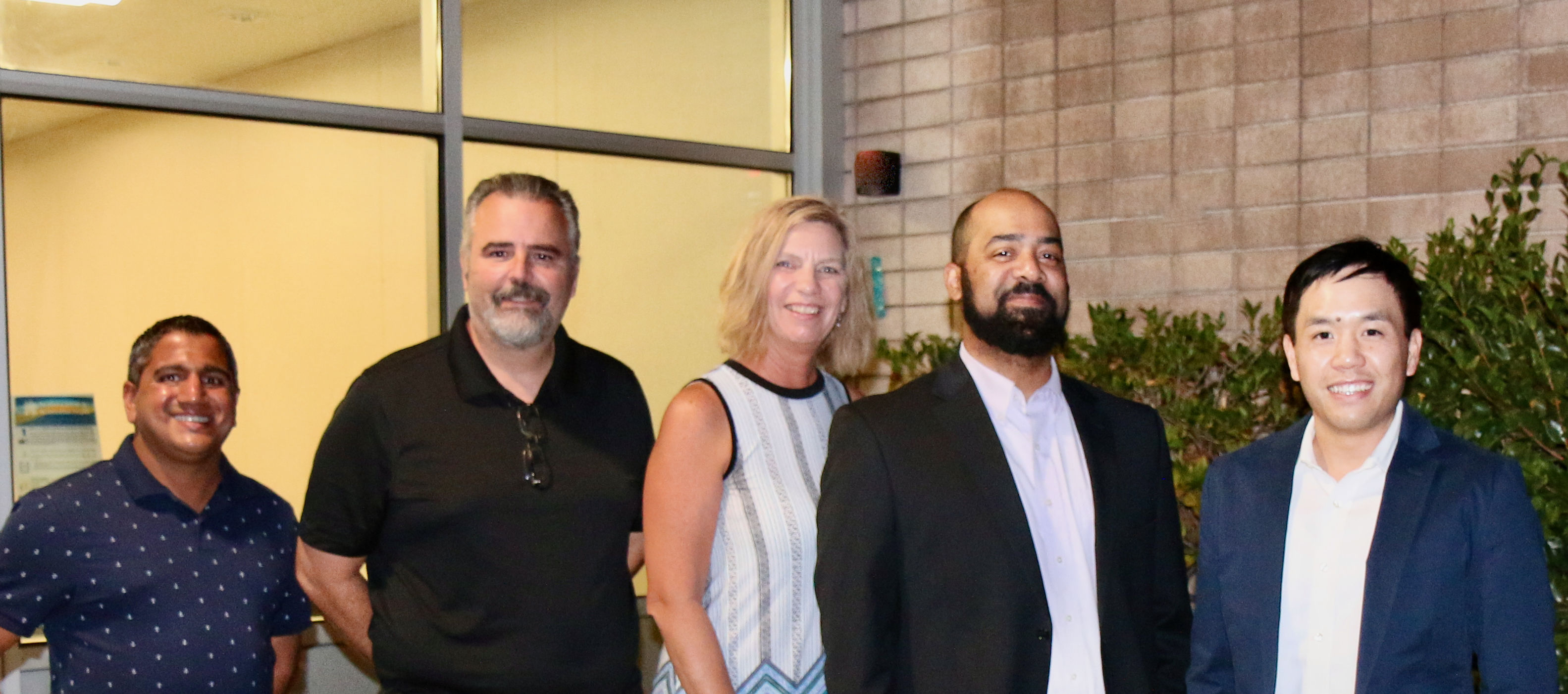 board members-4 men, one woman-standing