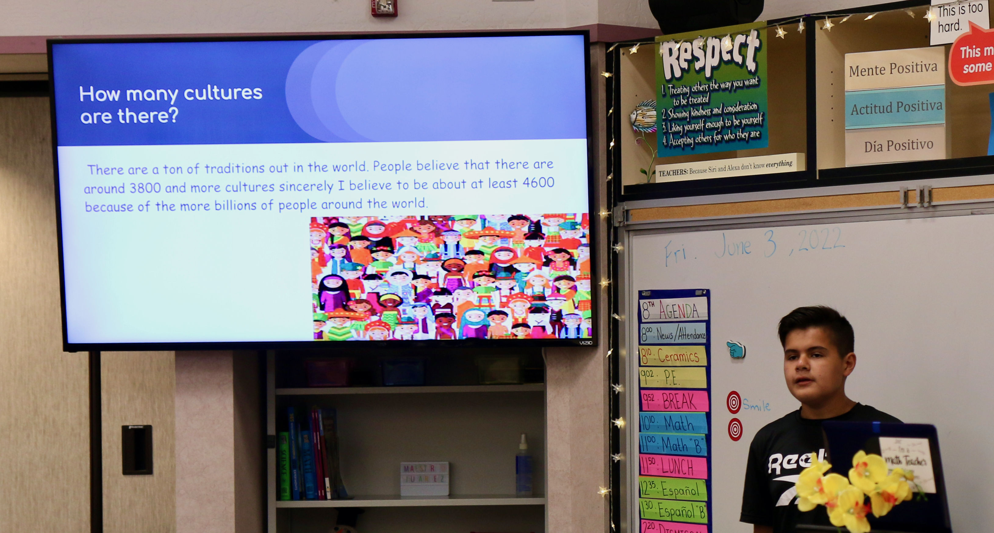 boy standing near large screen