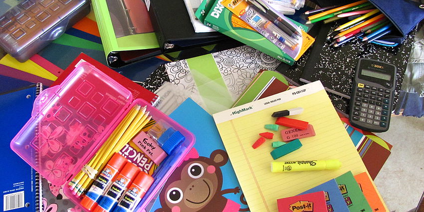 scattered assortment of various school supplies