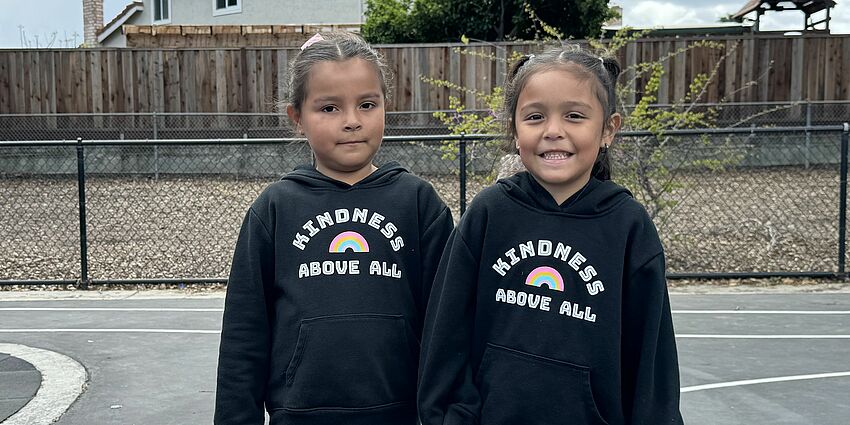 students with "kindness above all" shirts