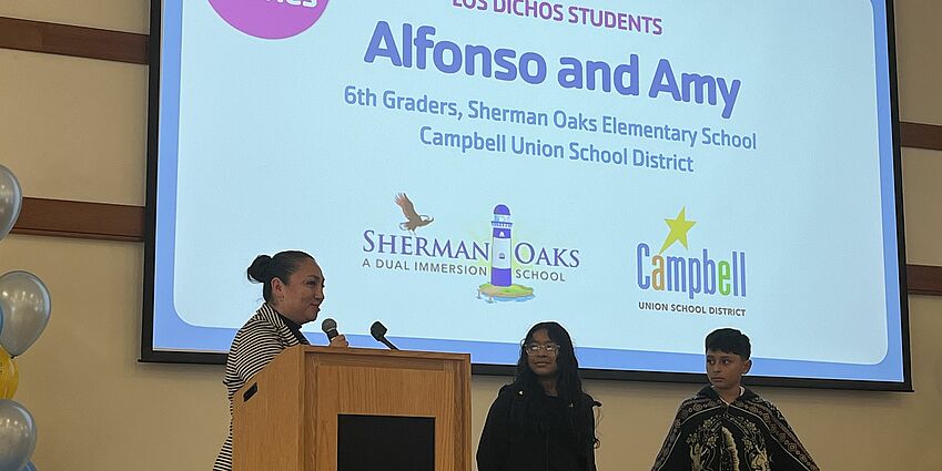 students presenting on stage