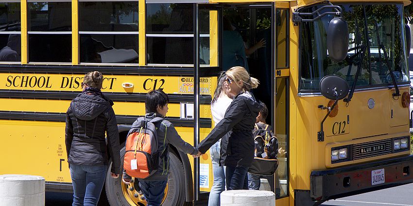 children boarding school bus