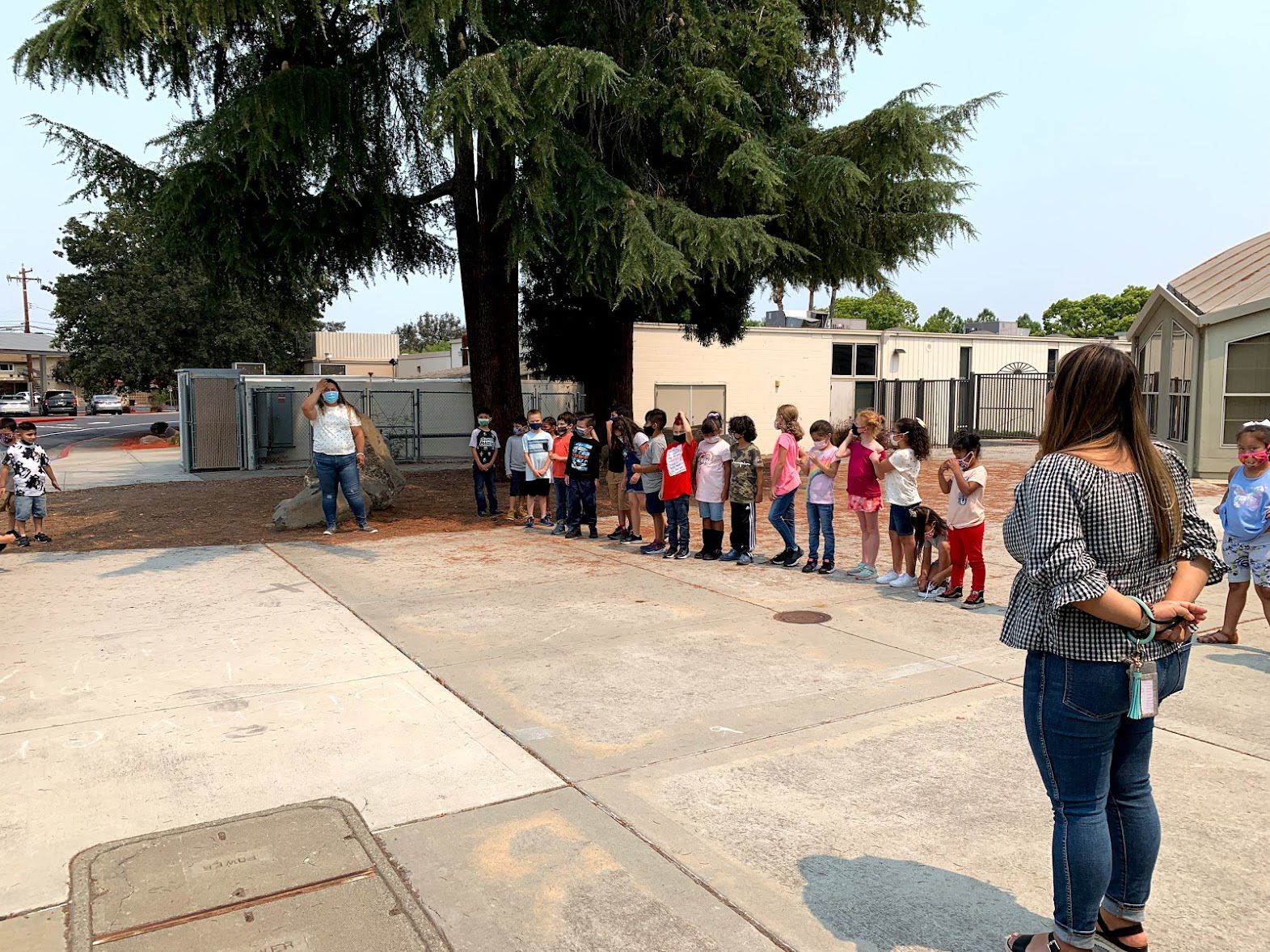 Teachers and students lined up outside of school