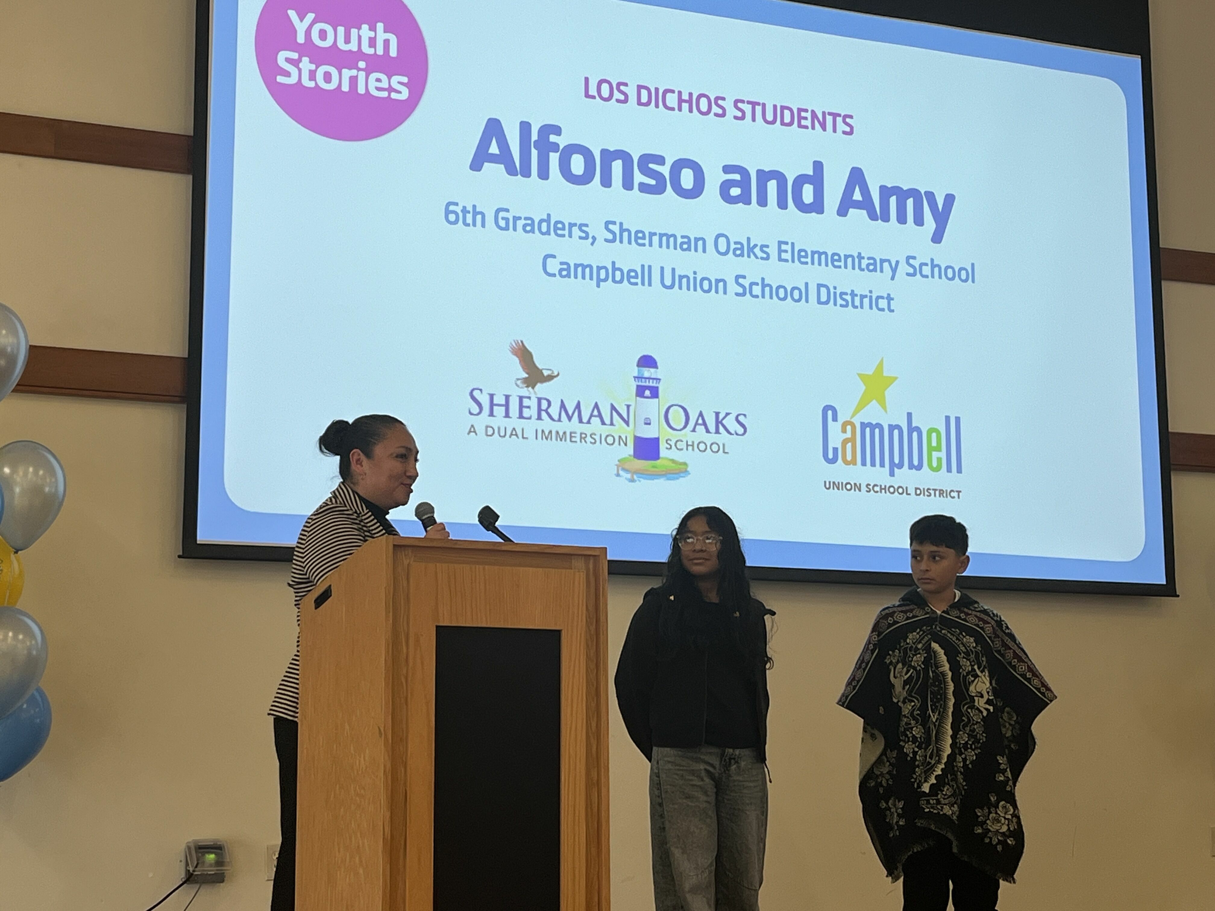 students presenting on stage