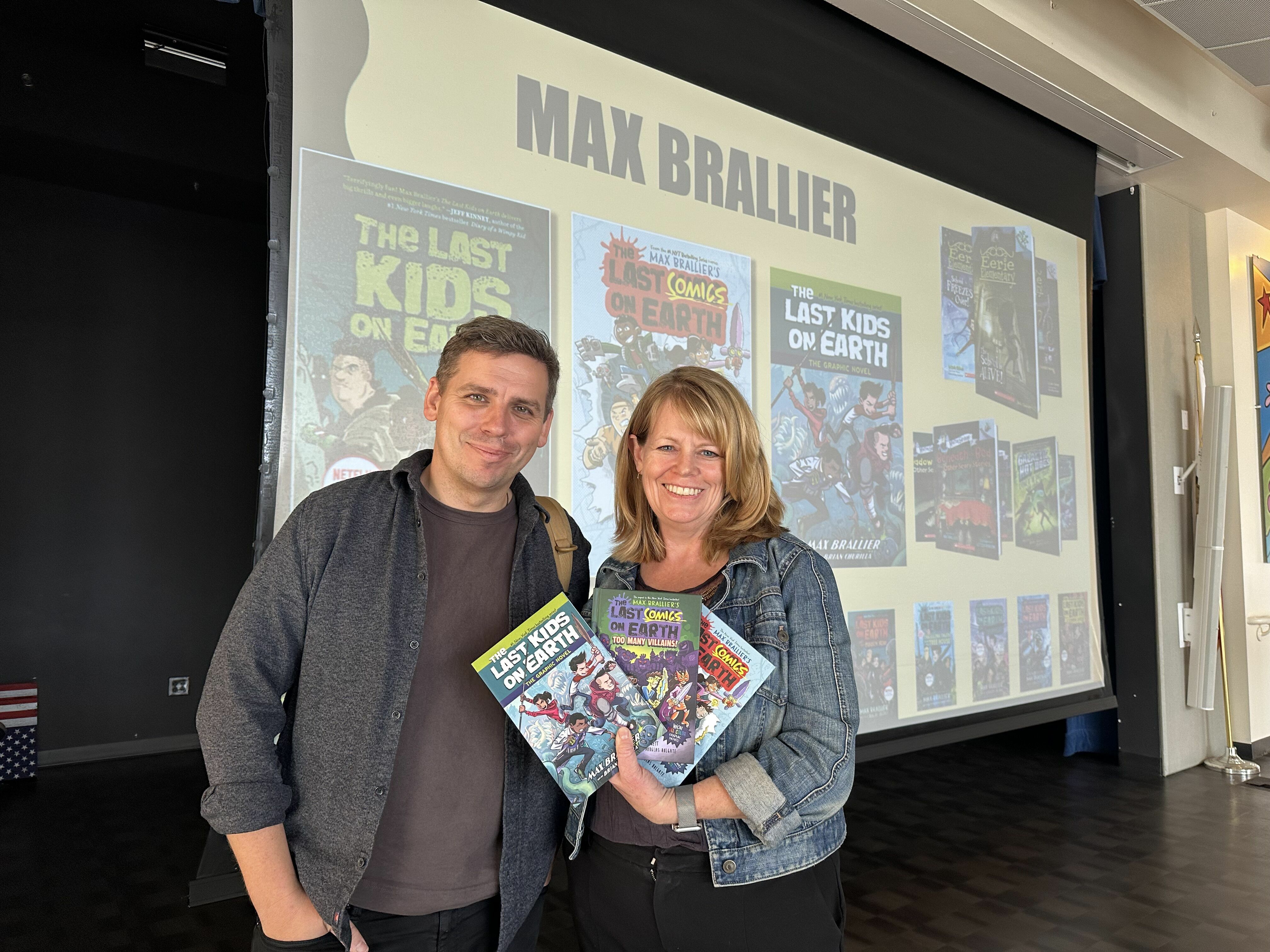 Author Max Brallier and Ms. Festa holding up his latest books